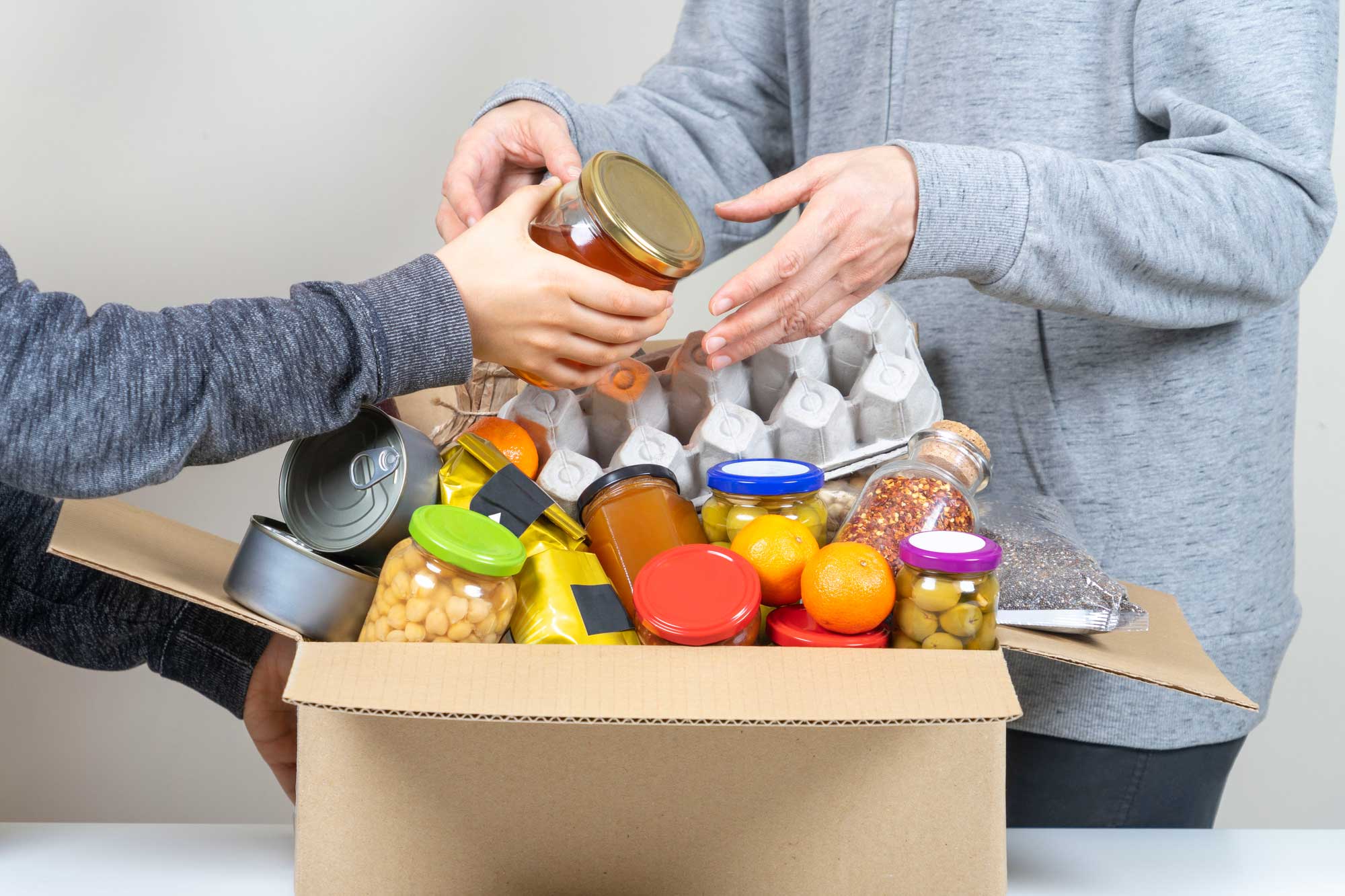 people filling a box with items