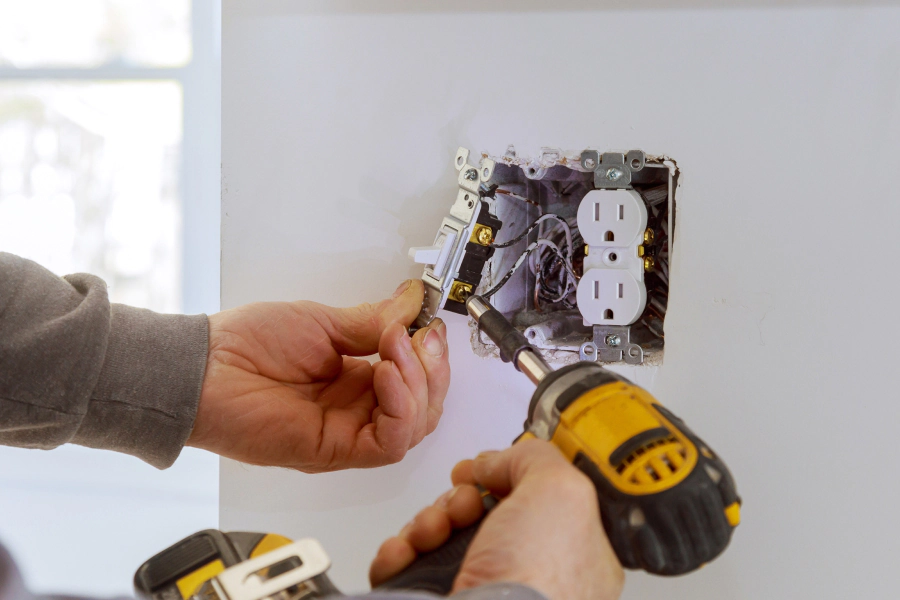 Person installing light switch