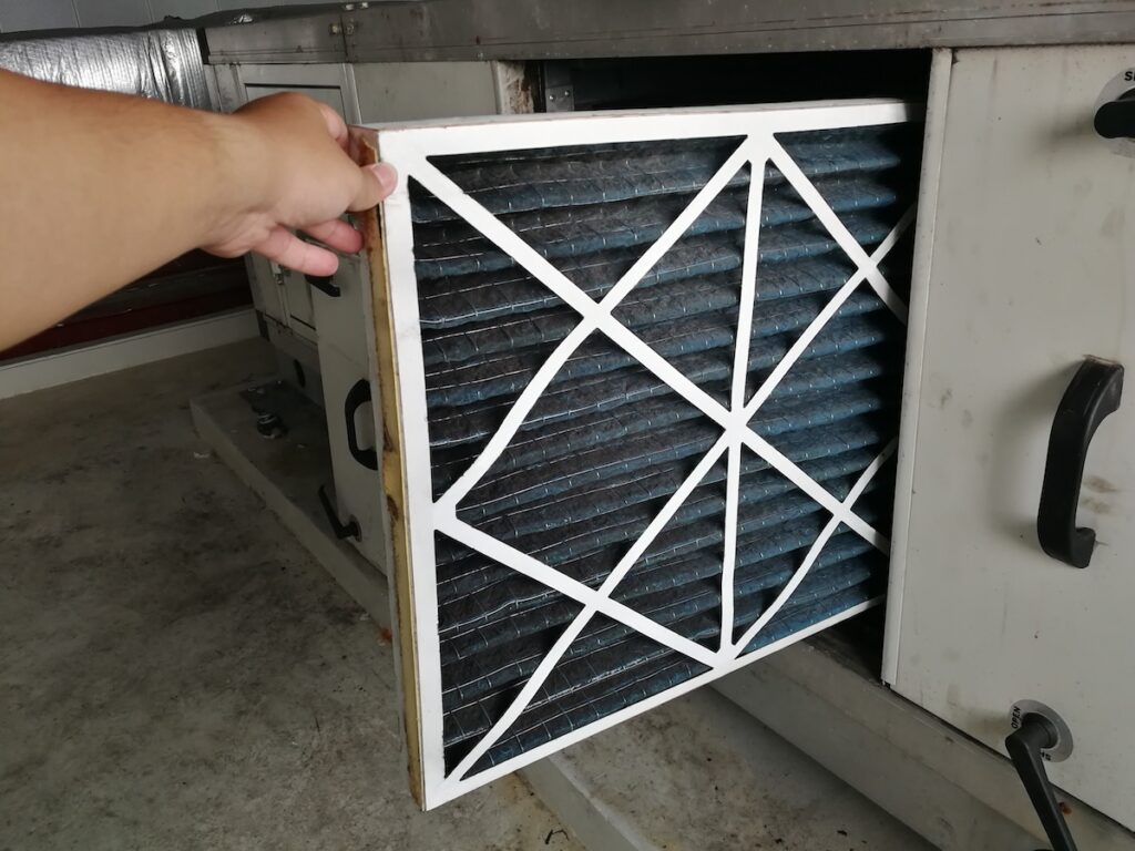 how often to change furnace filter Soft Focus to Filter of Air handing Unit, Technician checking a Pre-filter of air handling unit for replacement a new filter - HVAC maintenance