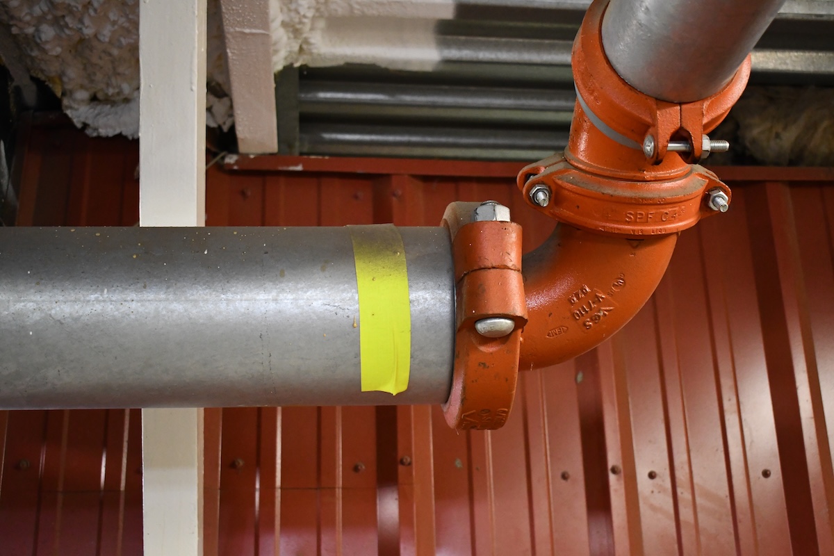 Large fire suppressor pipe under stadium grand stands.