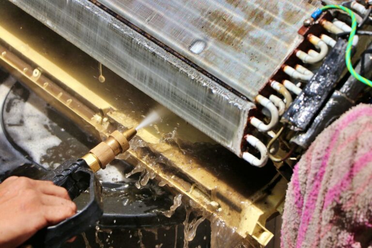 ac coil cleaner man holding pressure water gun cleaning air conditioner dirty coil inside house