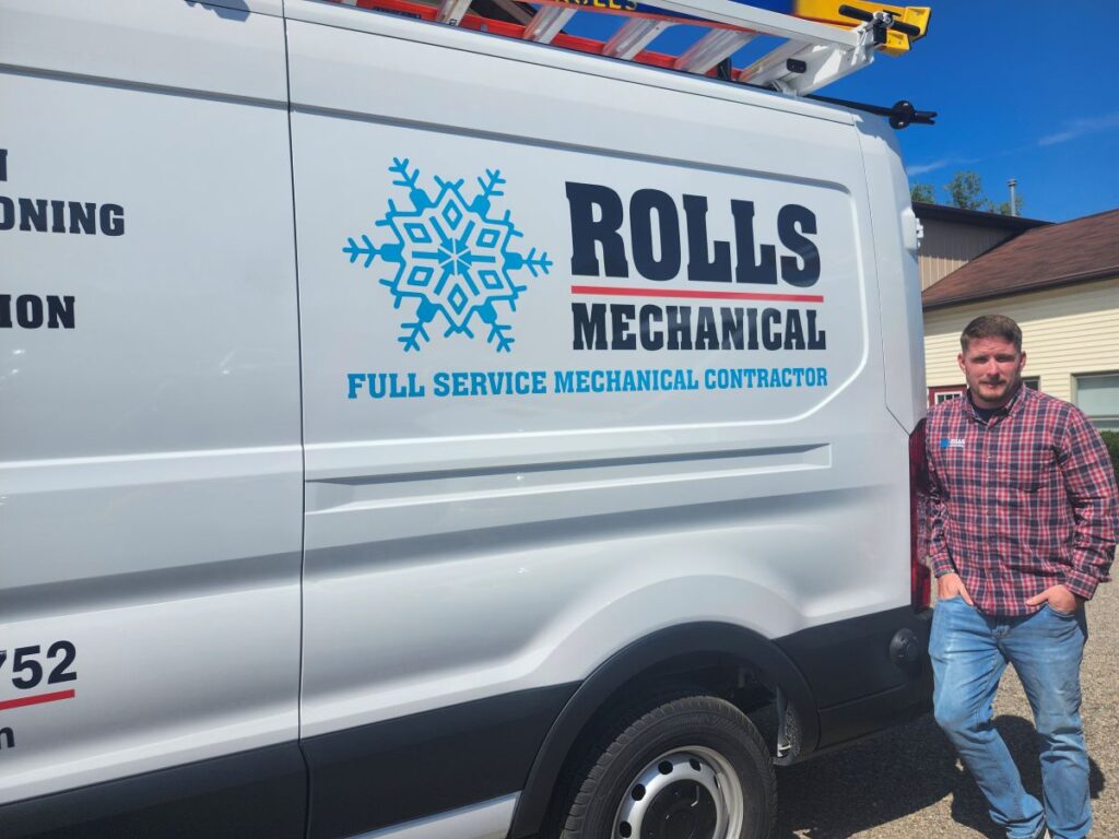 ac refrigerant Rolls Mechanical man standing next to branded white van