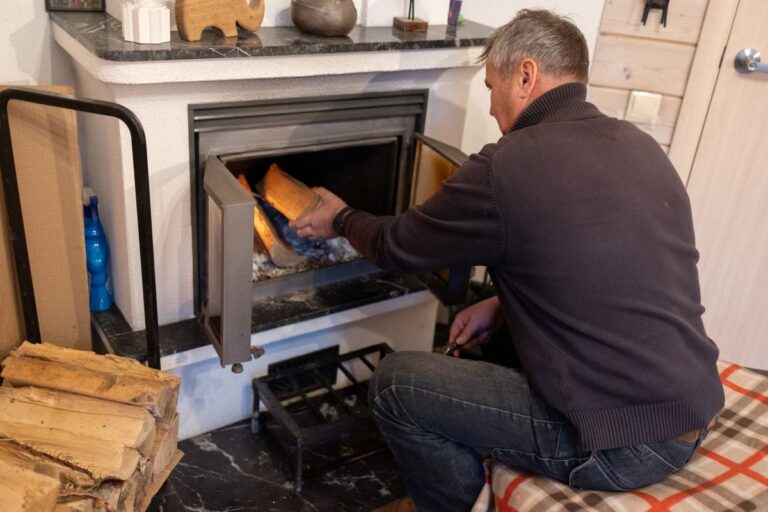 fireplace repair senior man replacing wood in old fireplace inside house