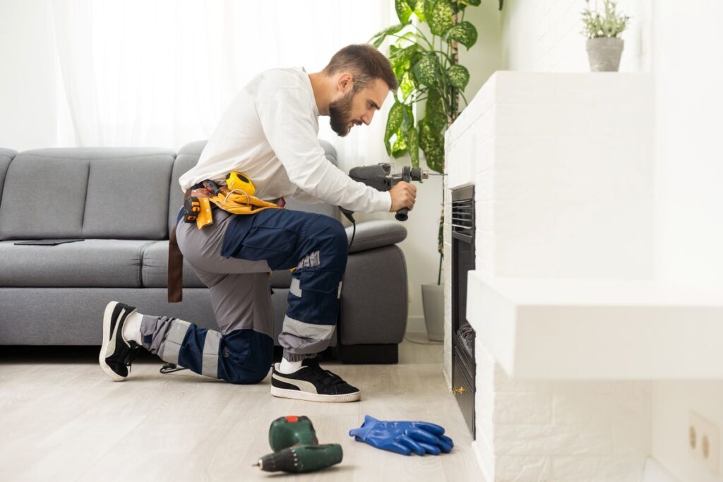 fireplace repair technician adjusting screwdriver modern electric fireplace