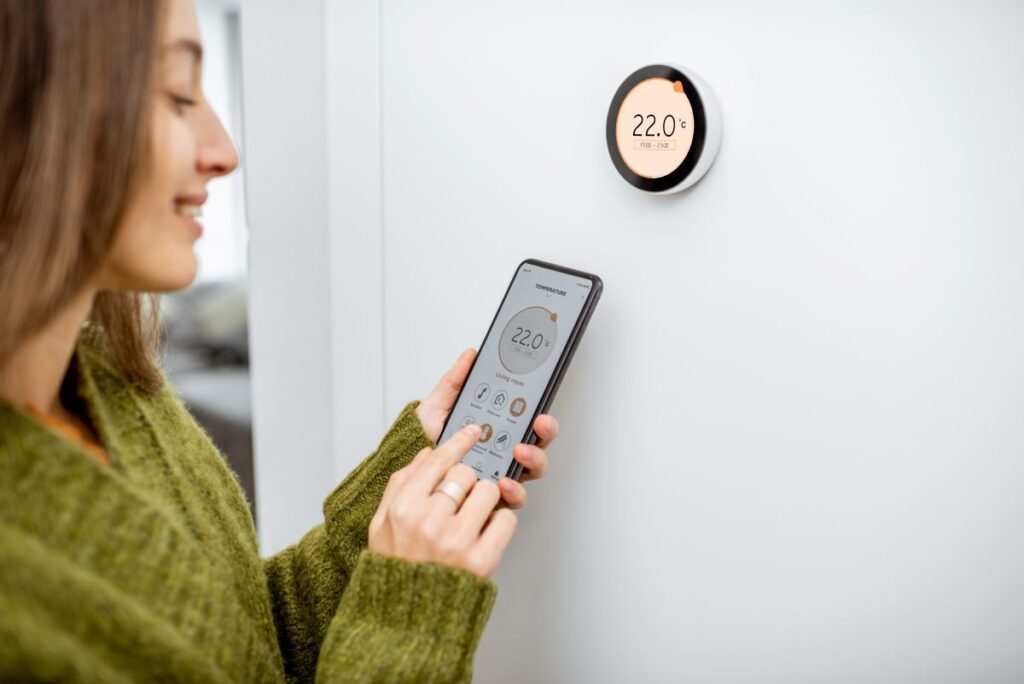 smart thermostat installation woman adjusting temperature inside home using app
