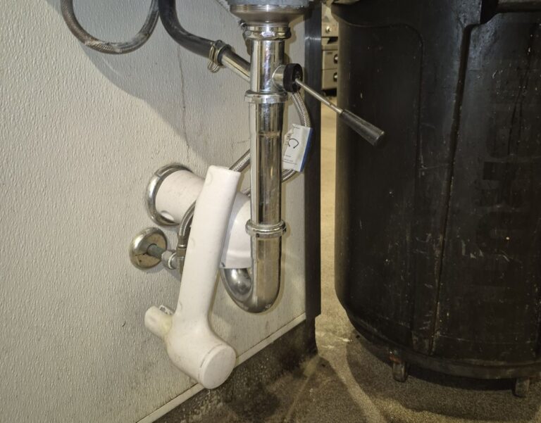 Close-up of plumbing under a sink