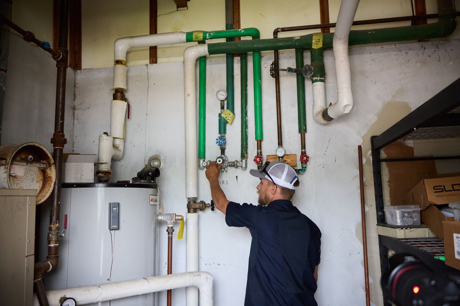 Pipes and a Rolls Mechanical team member working
