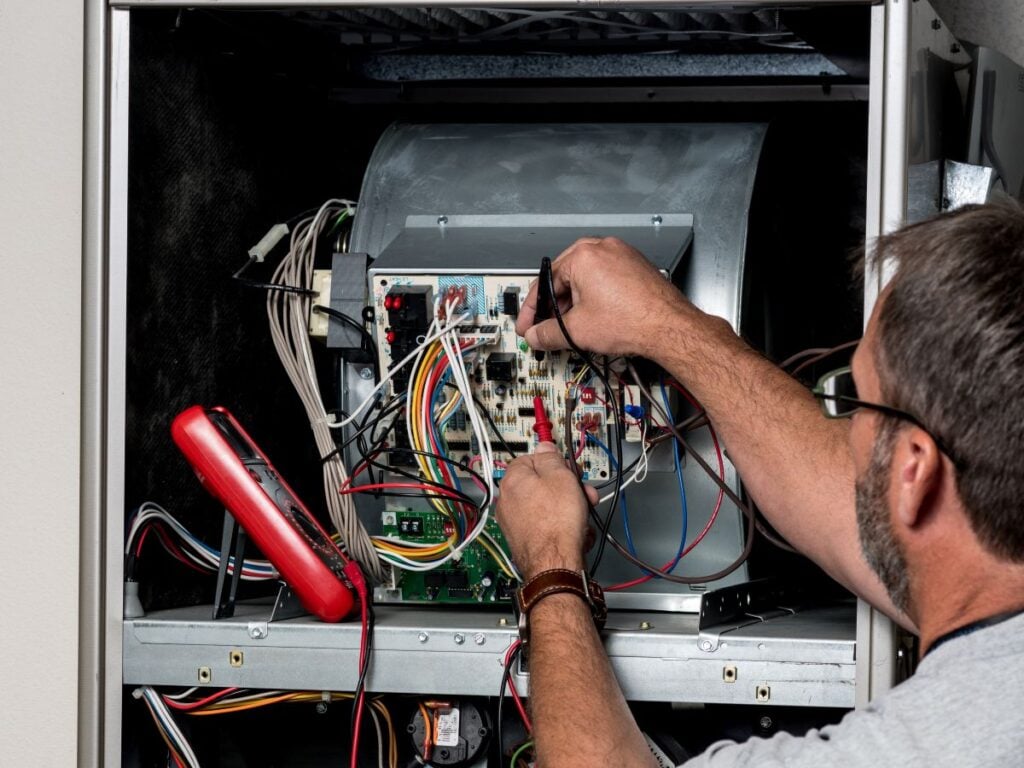 emergency furnace repair contractor repairing unit