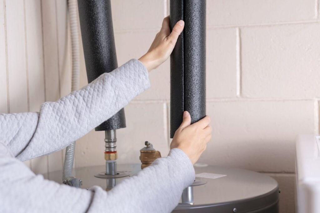 pipe insulation man installing