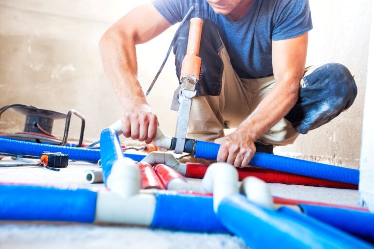 plumbing auburn hills worker repairing pipes inside facility