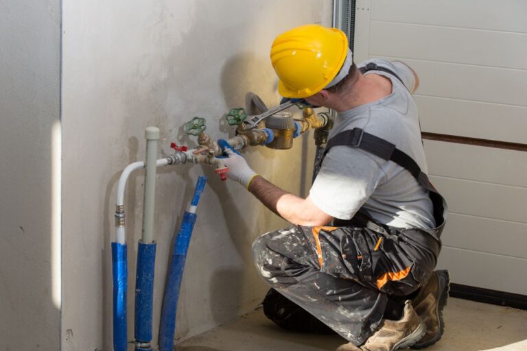 plumbing auburn hills worker using helmet repairing pipes