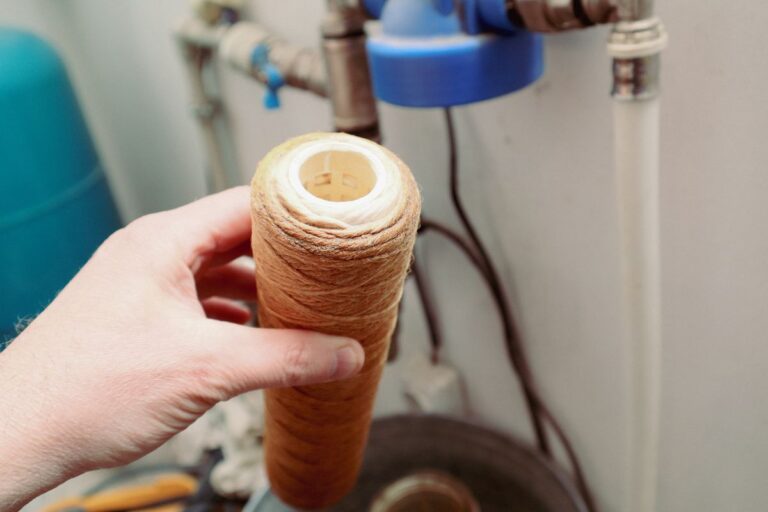 plumbing birmingham worker replacing water filter
