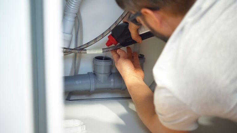 plumbing detroit worker repairing pipes