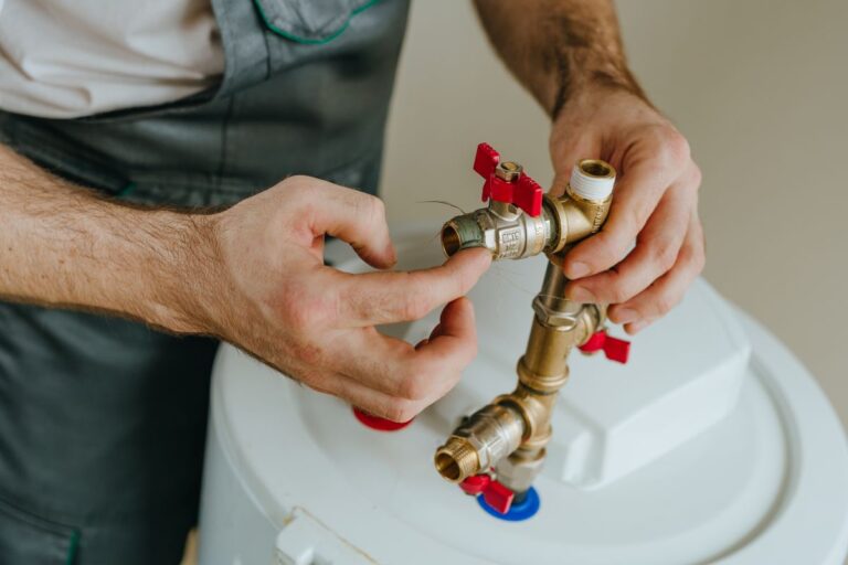 plumbing hartland hand fixing water heater