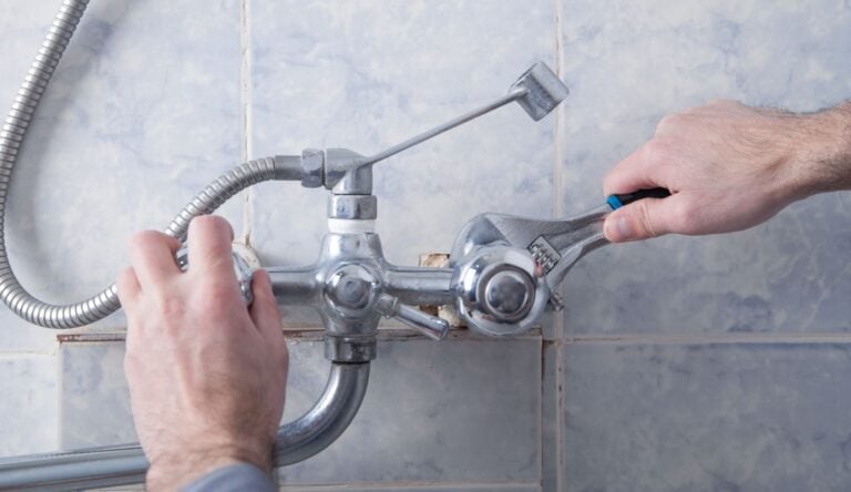 plumbing west bloomfield hands adjusting shower