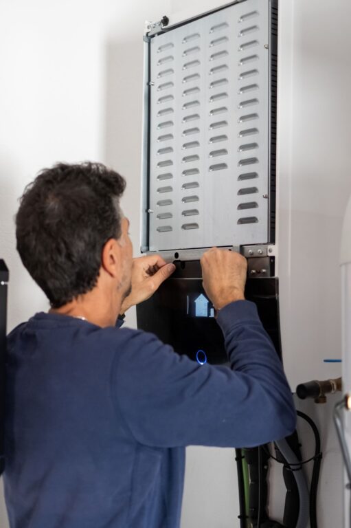 plumbing troy worker using blue shirt installing water tank