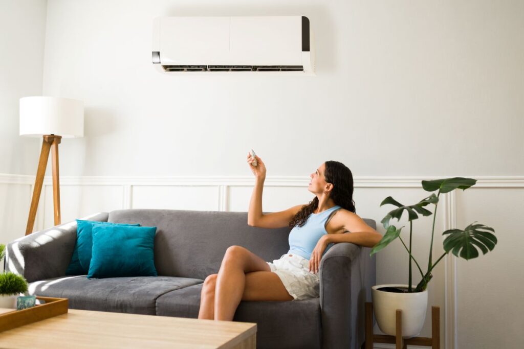 ac not turning on woman holding ac controller trying to turn it on