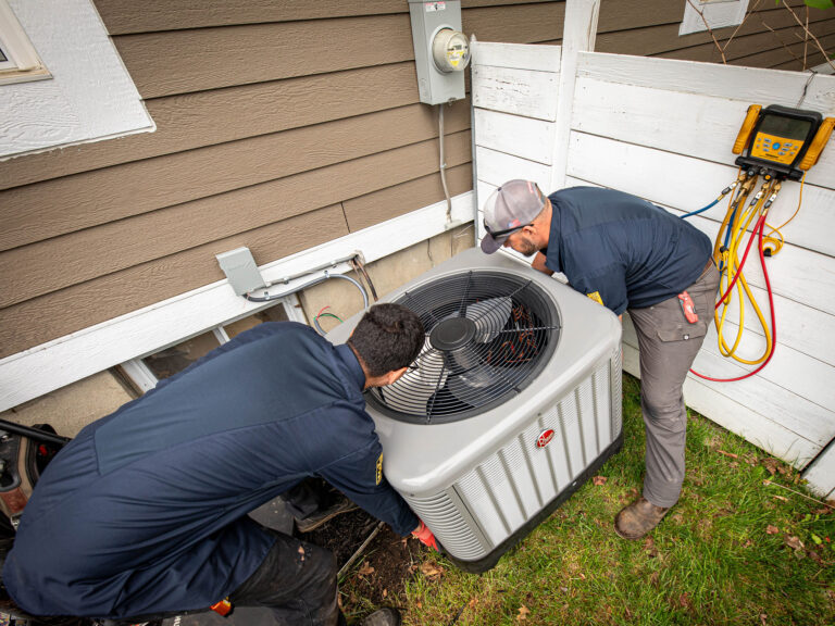 ac maintenance workers holding Air conditioner unit
