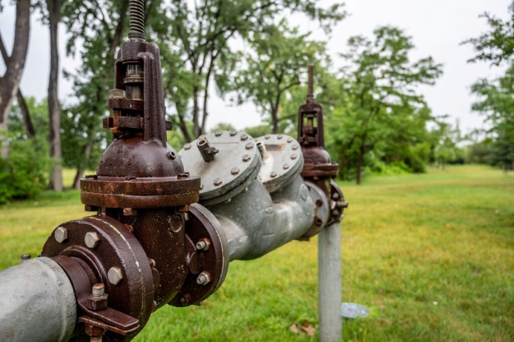 backflow preventer green grass background