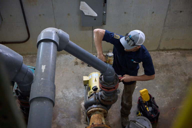 plumber swartz creek worker handling big pipe