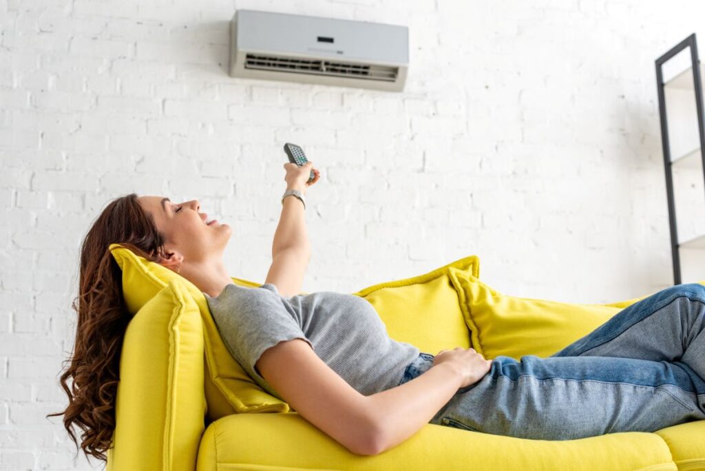 condensate pump woman enjoying ac unit inside house