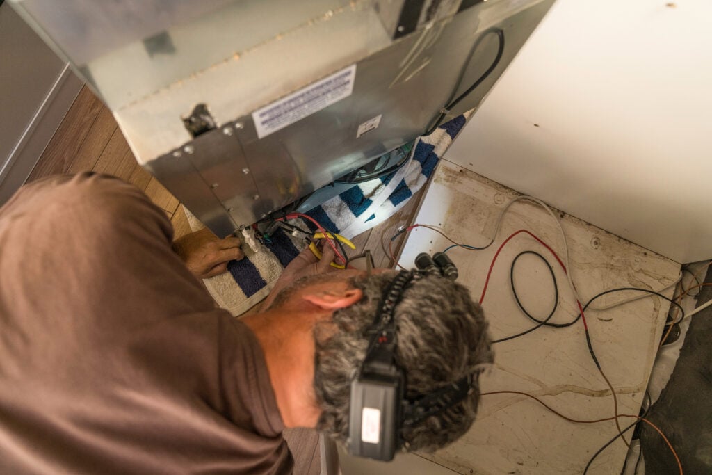 refrigeration cycle man repairing small refrigerator