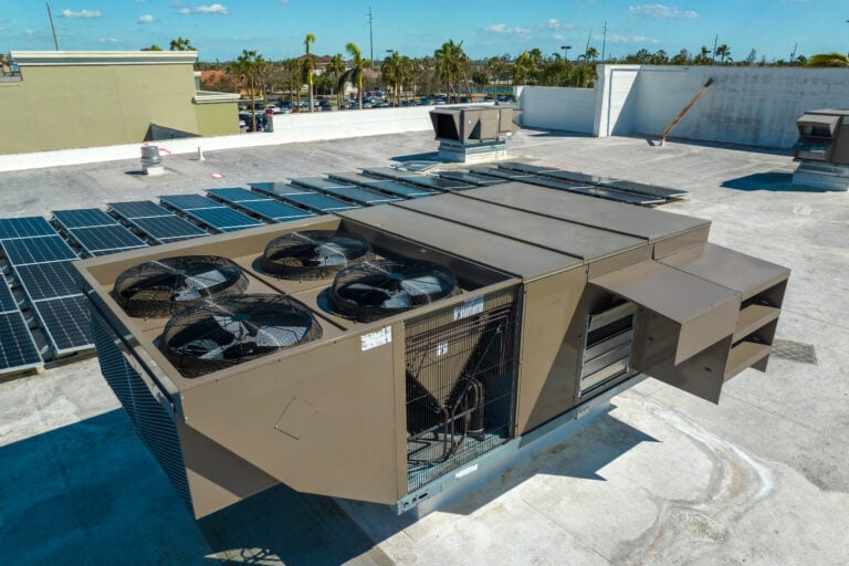 commercial ac unit External unit of commercial air conditioning and ventilation system installed on industrial building roof. Exhaust vent on flat factory rooftop.