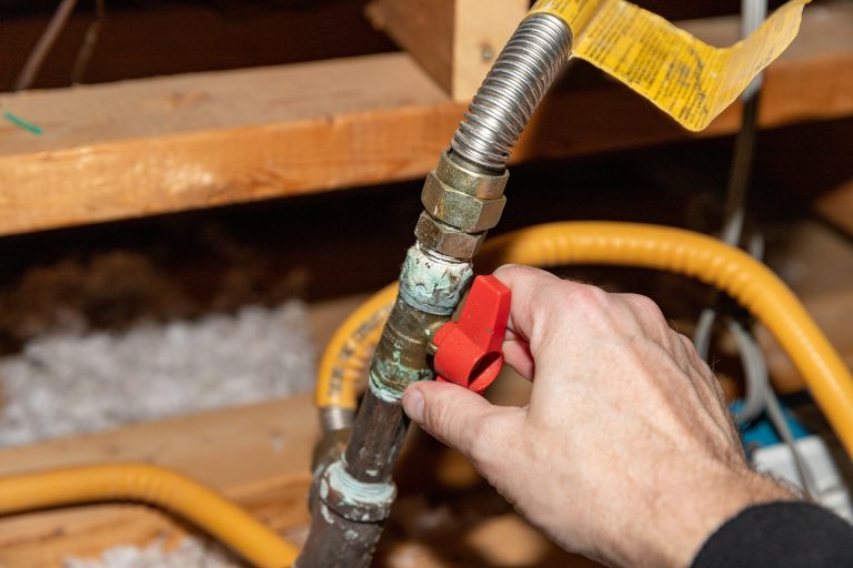 ductless mini split system Hand turning safety shut off valve of a natural gas pipe