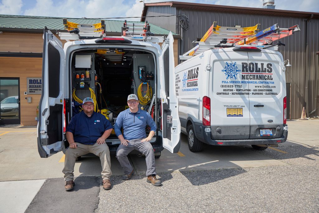 two guys sitting on van job